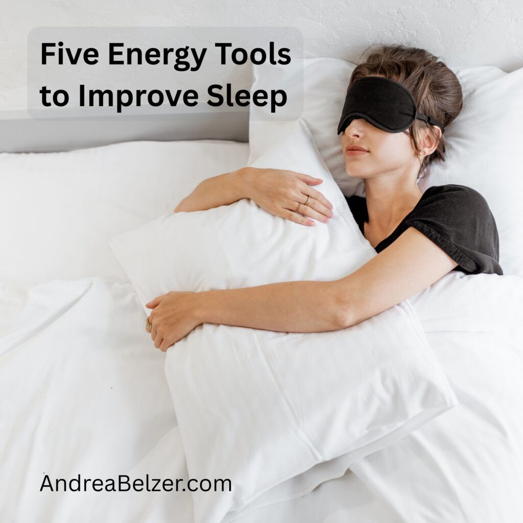 Woman sleeping with an eye mask while holding a pillow. Text overlay that says - "Five energy tools to improve sleep." and "andreabelzer.com"